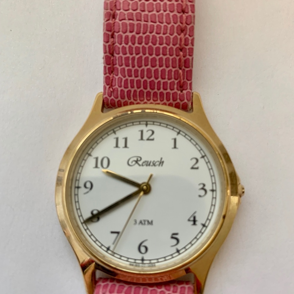 Gold and white face, pink strap watch